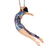 An advanced aerial student performs a neck hang from the Lyra at Roundabout Circus Studio in Wyoming