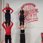 Four teenagers perform two highs next to the Nothing is Impossible in the Circus sign at Roundbouat Circus in Wyoming NSW. The teen class is a popular addition to our weekly schedule.