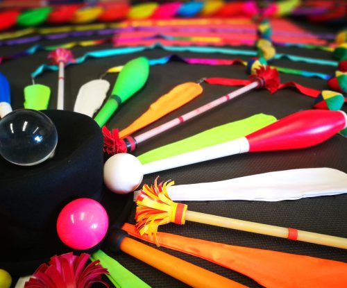 A variety of circus props juggling clubs, juggling balls, ribbons and a contact juggling ball